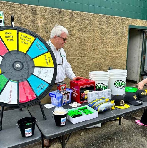 The prize table at the event featuring a big wheel participants could spin to win prizes.