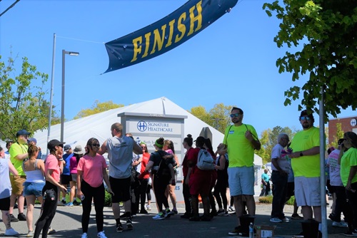 large congregation of people at the finish line of the walk at the Signature Healthcare Brockton Hospital entrance 