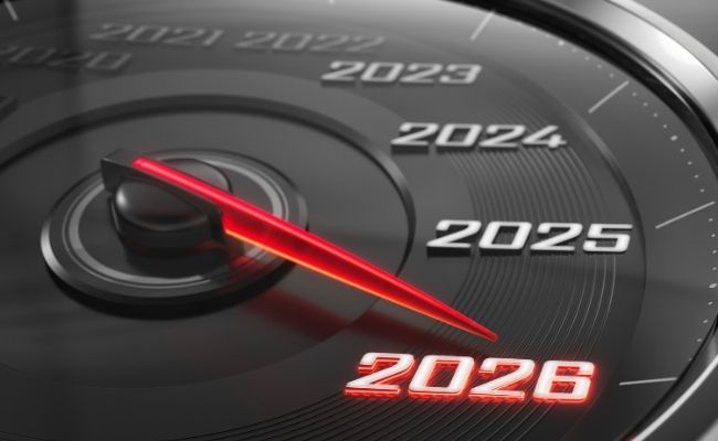 A vehicle speedometer with the years 2021-2026 on it. The needle is pointed to 2026 in red.
