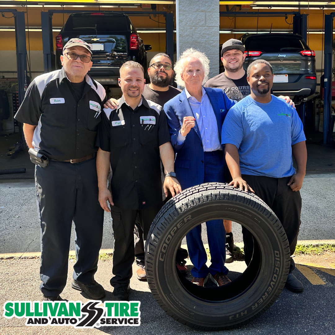 Paul Sullivan standing proud with a group of Sullivan Tire employees