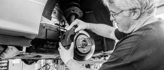 Auto Technician Inspecting Brakes
