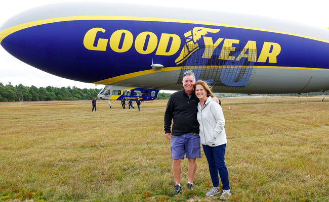Goodyear Blimp Passengers in front of the Blimp