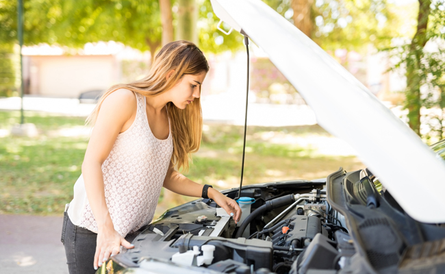 Woman Checking Under the Hood of a Car